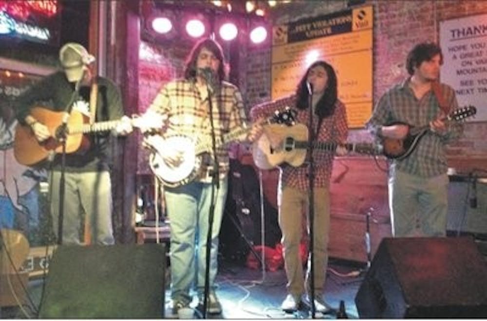 Bernard Breitung, Daniel Raine, Davis Little and Zach Drew perform at Moe's Barbeque. (Caitlin Wagenseil) / INTRIGUE REPORTER