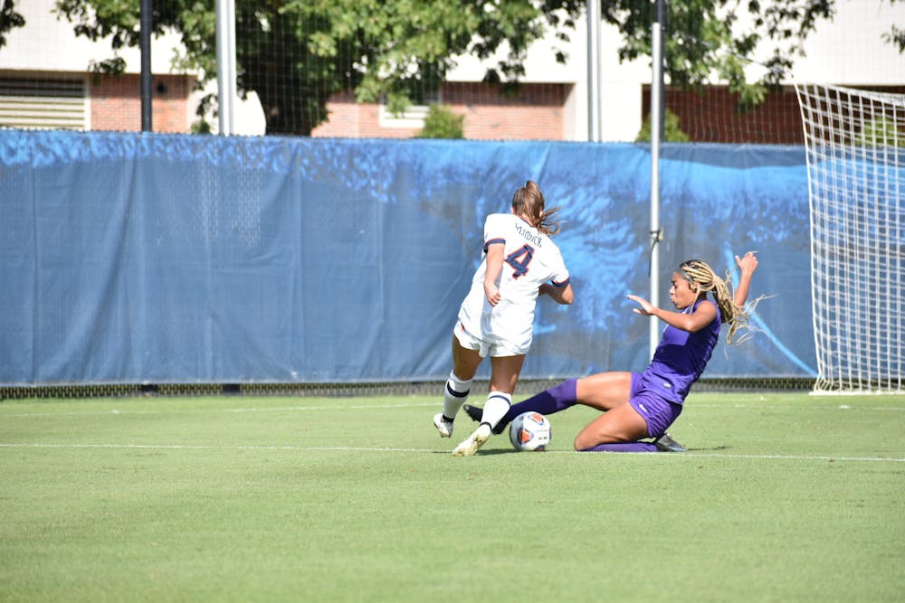 <p>Oct. 10, 2021; Auburn, AL, USA; Anna Haddock (4) attempts to push through an incoming tackle in a match between LSU and Auburn at the Auburn Soccer Complex.</p>