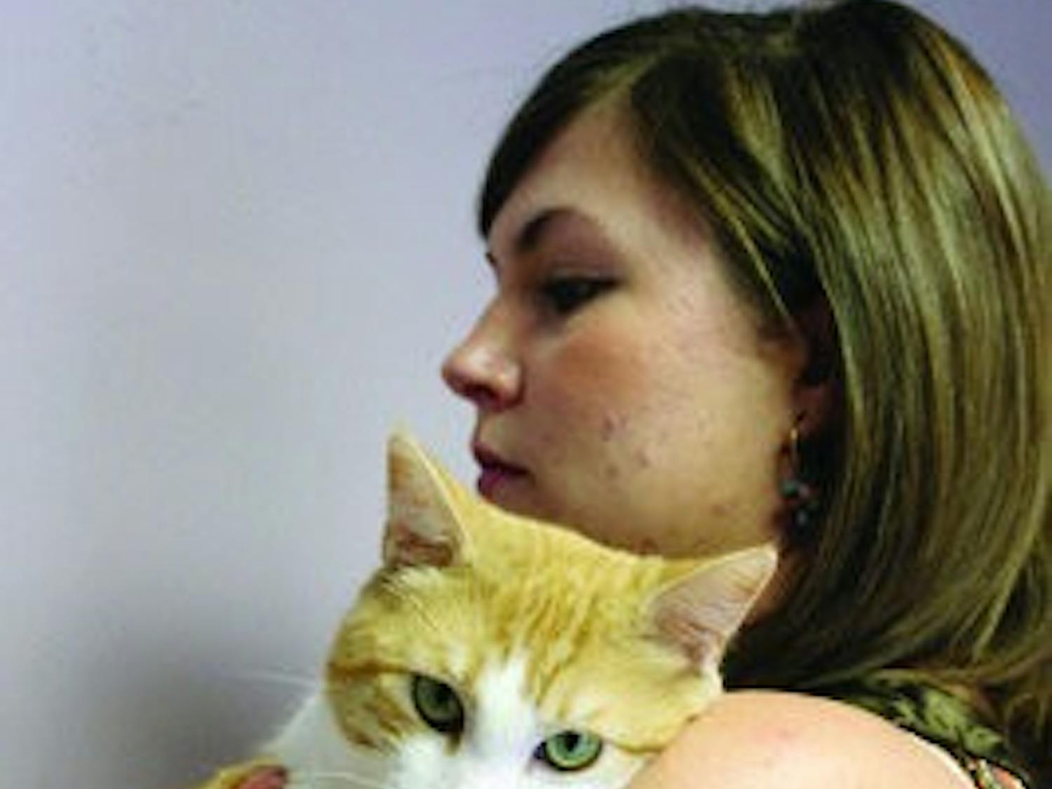 Stacee Peer loves on cat looking for adoption. (Alex Sager / PHOTO EDITOR)