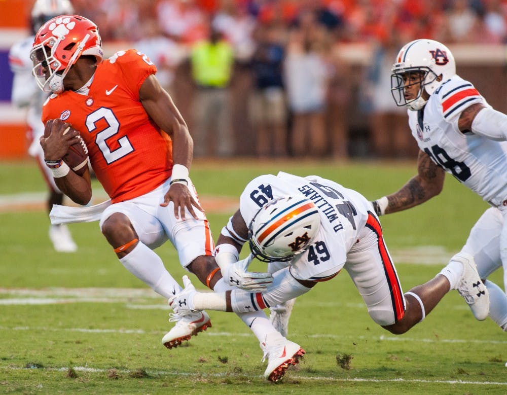 Auburn linebacker Darrell Williams (49) tackles Clemson quarterback Kelly Bryant (2) in the first half. Auburn vs Clemson on Saturday, Sept. 9 in Clemson, S.C.