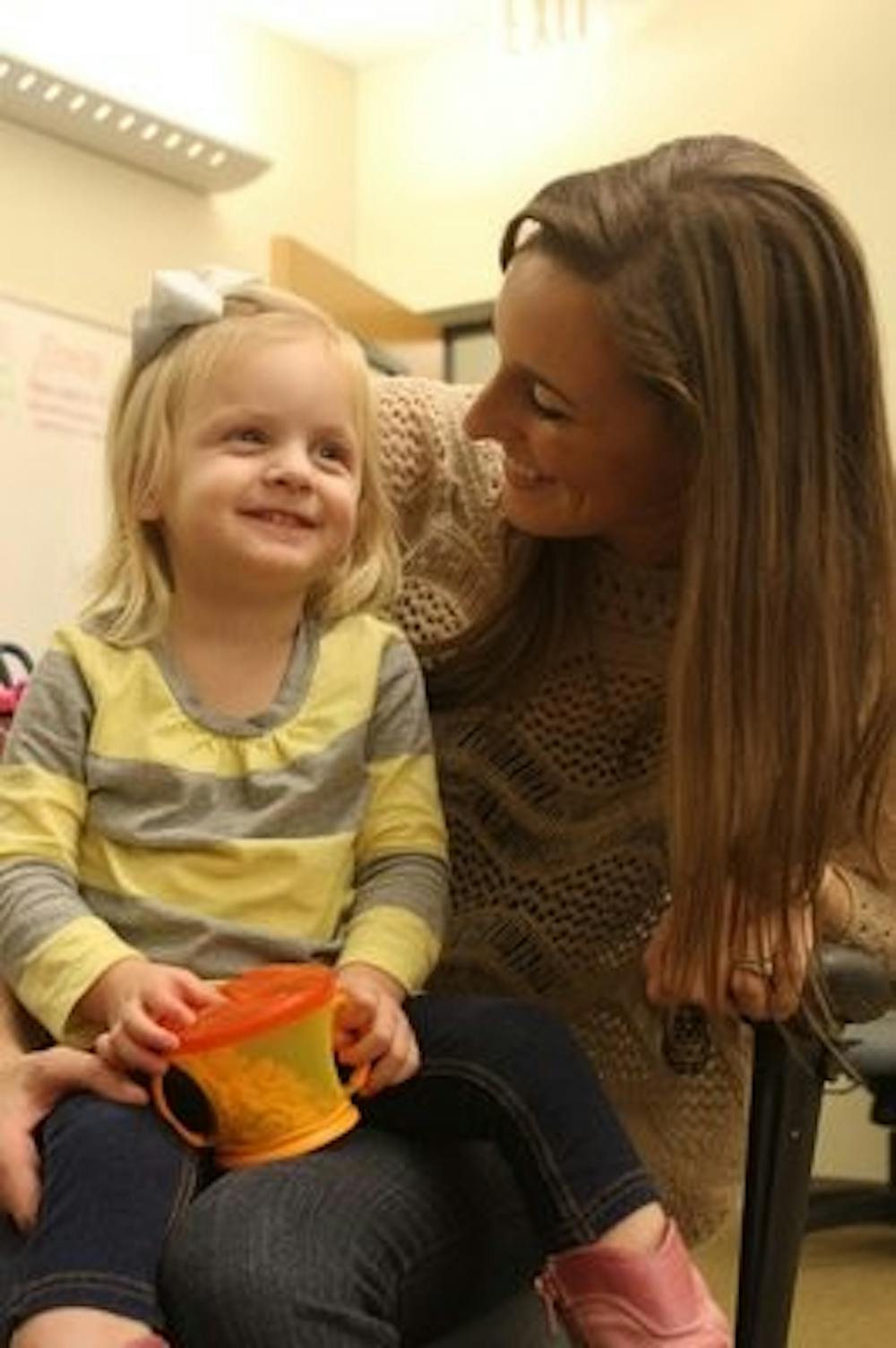 Lauren Litchfield, pictured with her 2 year old daughter, Ava Hayes, speaks out about the trials and joys of being a mother while attending school before graduating last December. Litchfield graduted a semester early with a degree in marketing.
(Katherine McCahey / ASSISTANT PHOTO EDITOR)