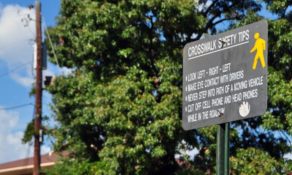 A crosswalk safety tips sign sits at a crosswalk that extends from campus to Chipotle on&nbsp;West&nbsp;Magnolia Avenue on&nbsp;on Thursday, Nov. 3, 2016, in Auburn, Ala.