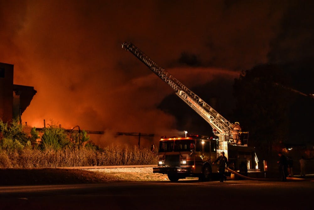Auburn fire fighters battle a fire at Leshner Mill, Tuesday, Nov. 15, 2016 in Opelika,Ala.