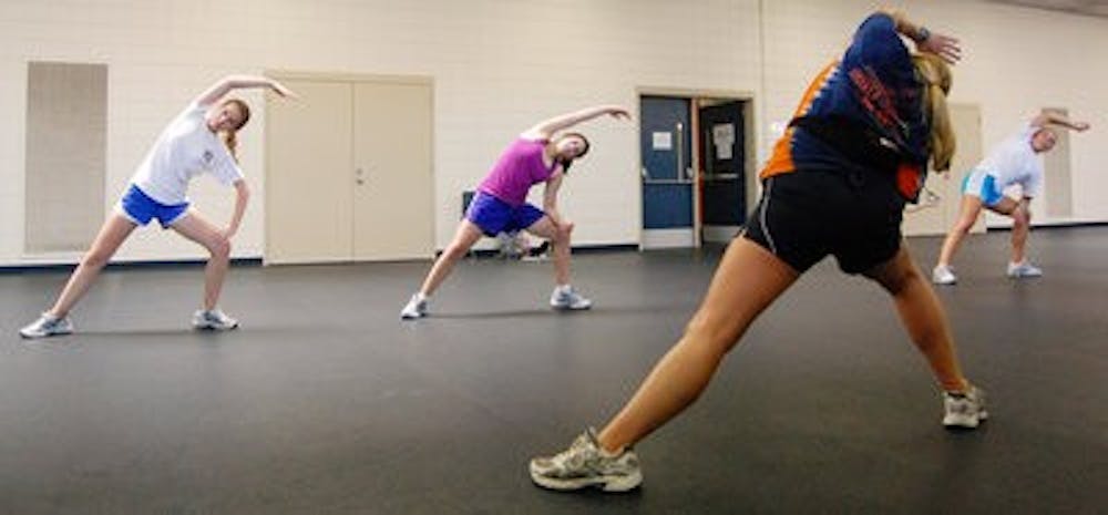 Junior Alyssa Murff (left to right), freshman Katie Gauthier and freshman Jerica Pealor follow sophomore instructor Emily Quinn's cardio routine at the Student Activities Center. (Charlie Timberlake / ASSISTANT PHOTO EDITOR)
