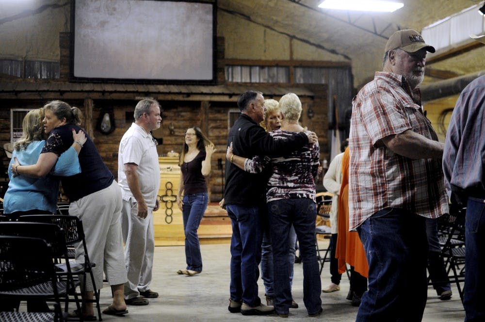 Members of the Cowboy Church greet each other on April 22, 2018, in Waverly, Ala.