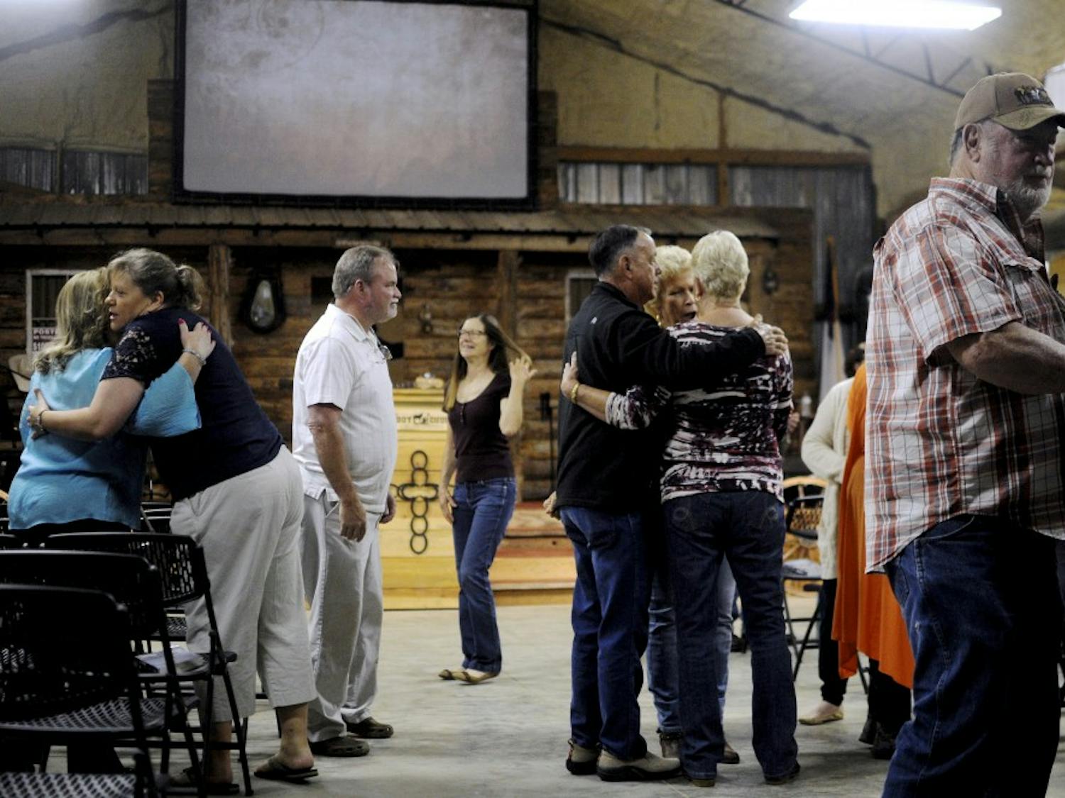 Members of the Cowboy Church greet each other on April 22, 2018, in Waverly, Ala.