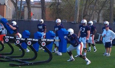 Offensive line coach J.B. Grimes watches his offensive line block. Grimes' points of emphasis Friday were keeping his players' hips square and elbows in tight. (ANDREW YAWN / SPORTS REPORTER)