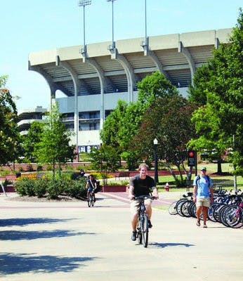 David Pierce, junior in management, rides his bike home from class. Bikers are a common sight on campus and throughout Auburn, used for both recreation and transportation. (Alex Sager / ASSOCIATE PHOTO EDITOR)
