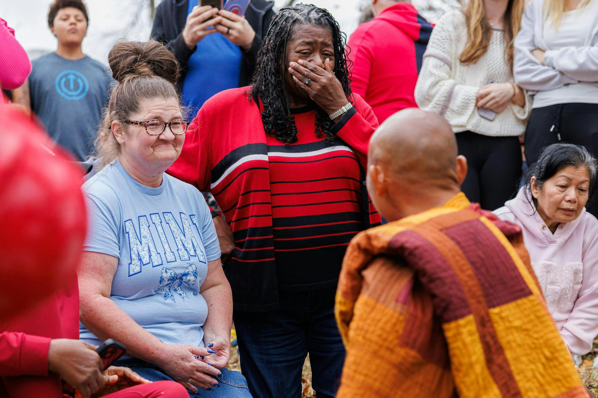 Two women express emotion after a moment of mindful presence with Venerable Monk Bhikkhu Pannakara during the lunch stop in Cusseta, Ala. on Dec. 26, 2025.