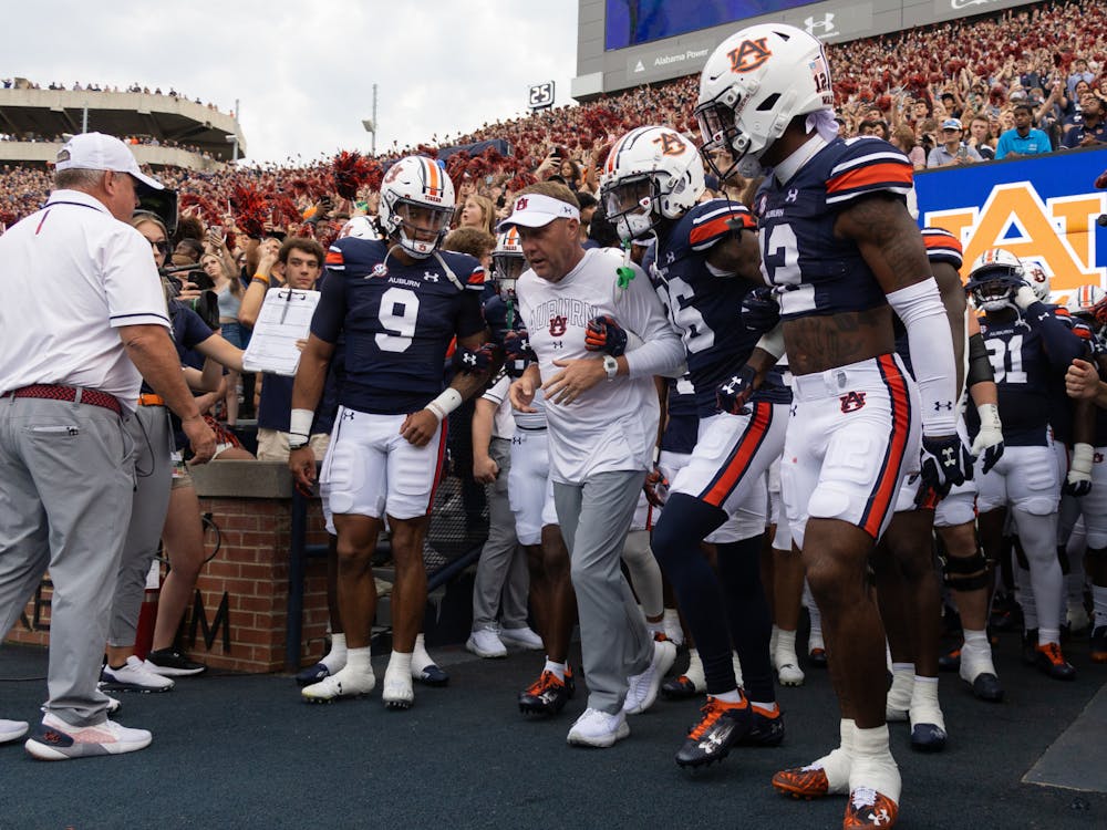 <p>Hugh Freeze leads his captains out of the tunnel versus Samford</p>