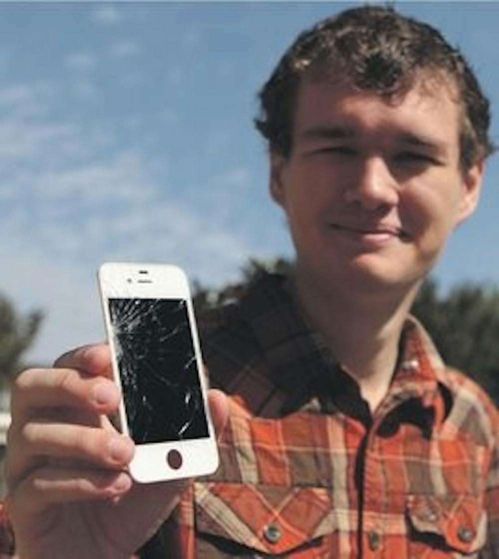 Asher Smale, sophomore in graphic design, repairs iPhone screens as a hobby and a business. (Rebecca Croomes / PHOTO EDITOR)