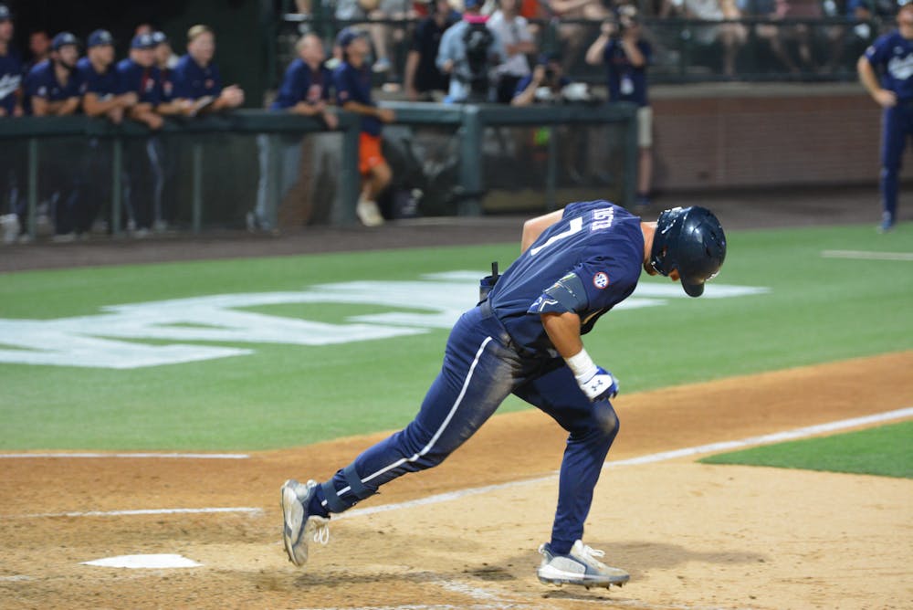 <p>Cole Foster heads for first after hitting a fly ball when Auburn went to extra innings against Penn in the team's opening game of its NCAA Regional on Friday, June 2, 2023.</p>