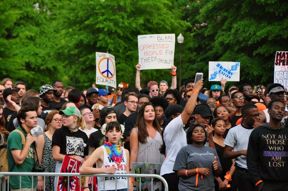 Student chant on the Green Space, holding signs in protest of&nbsp;white nationalist Richard Spencer, who spoke the same evening on Tuesday, April 18, 2017, in Auburn, Ala. The march, led by Black Auburn, was planned in conjunction with&nbsp;the Auburn Unites concert.