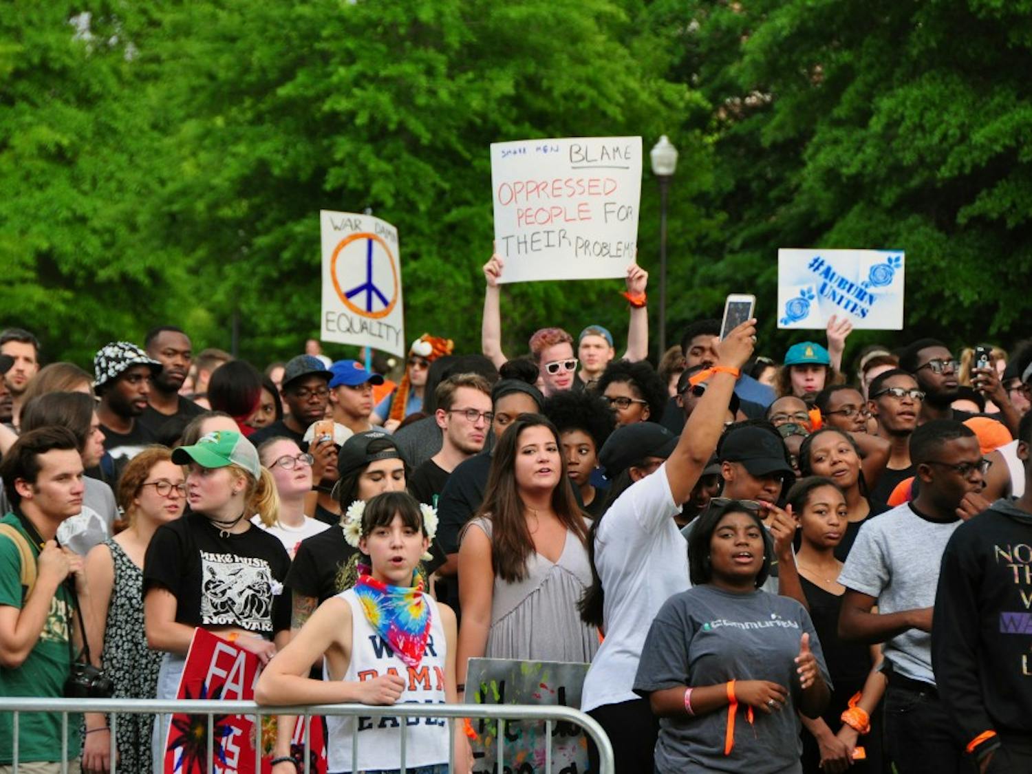 Student chant on the Green Space, holding signs in protest of&nbsp;white nationalist Richard Spencer, who spoke the same evening on Tuesday, April 18, 2017, in Auburn, Ala. The march, led by Black Auburn, was planned in conjunction with&nbsp;the Auburn Unites concert.