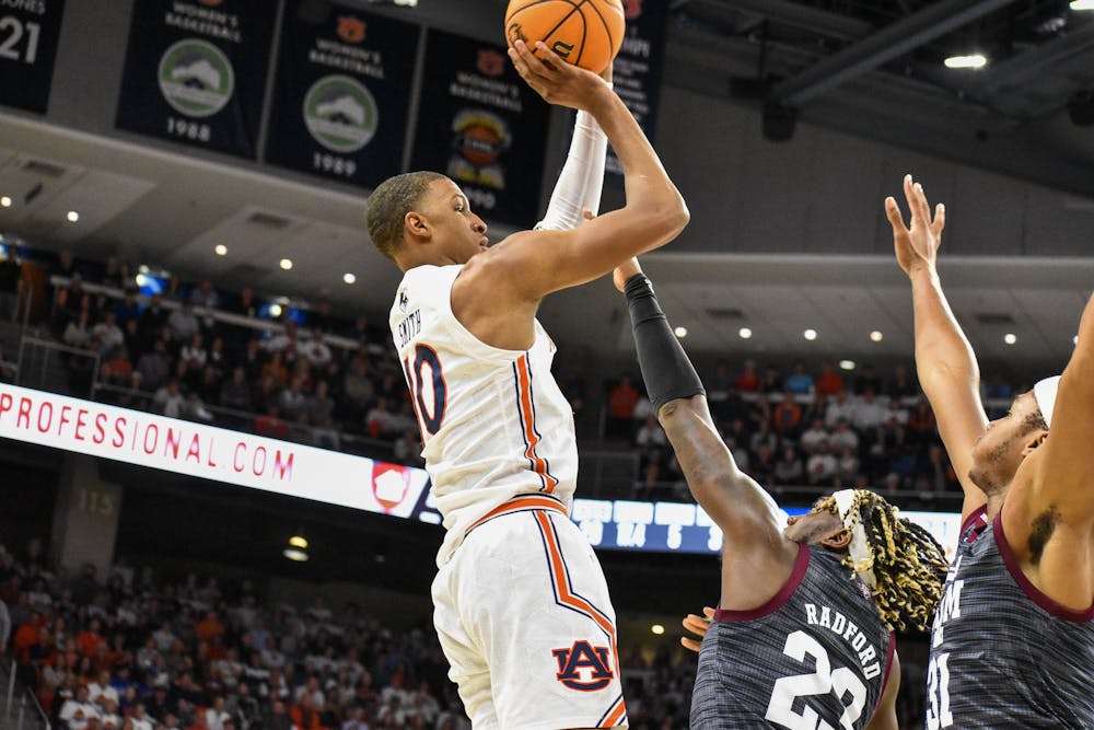 February 12, 2022; Auburn, Alabama; Jabari Smith (10) takes a contested jumper over two Aggie defenders in a match between Auburn and Texas A&M in the Auburn Arena.