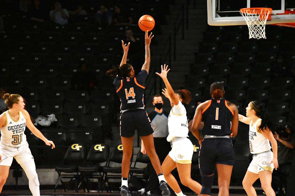 <p>Nov. 21, 2021; Atlanta, GA; Jala Jordan (14) hits a jumper over a Yellow Jacket defender in a match between Auburn and Georgia Tech.</p>