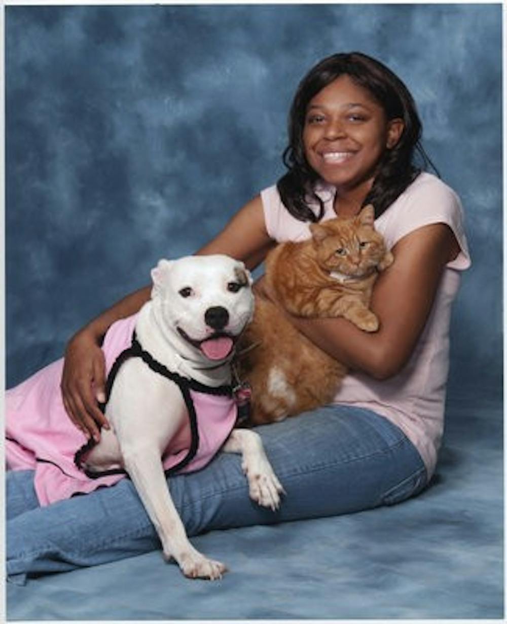 April Dixon, freshman in animal science, sits with her dog Crystal and cat Mr. Whiskers, who she credits with helping her control her paranoid schizophrenia. (Contributed by April Dixon)