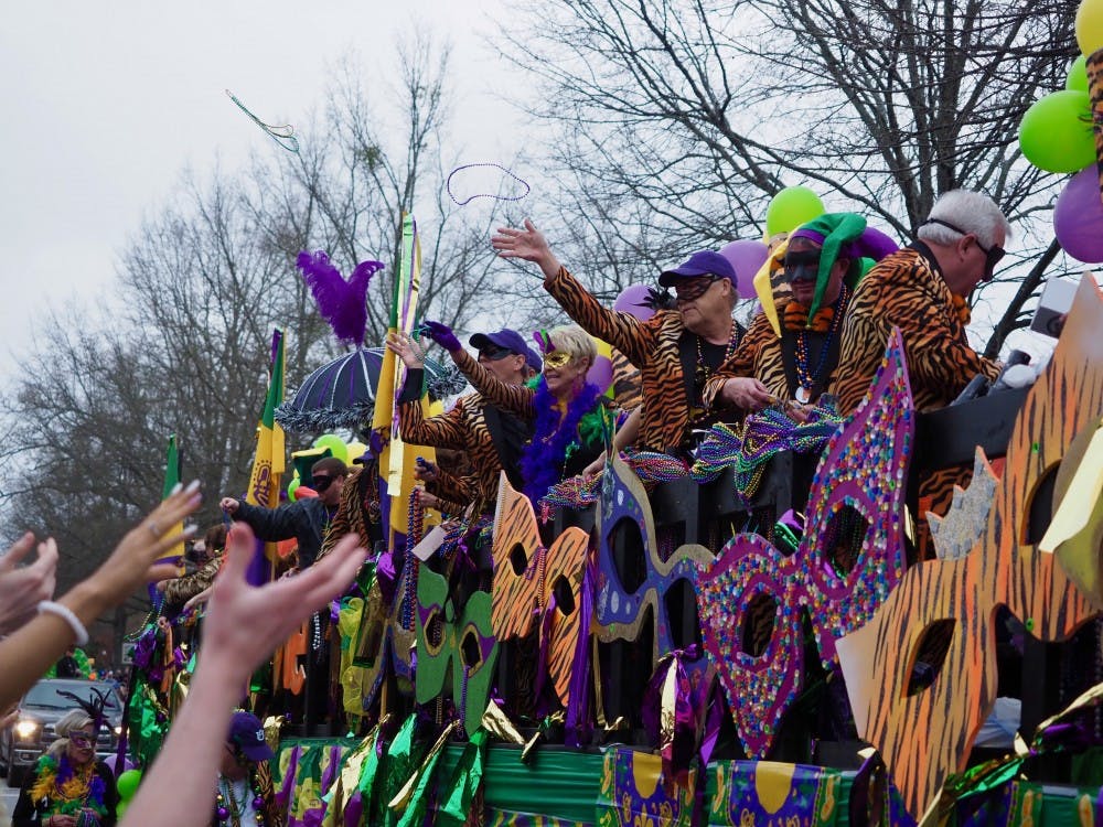 Parade float throws beads to the crowd at the Auburn Mardi Gras Parade on Sat, Mar. 2, 2019 in Auburn, Ala.    
