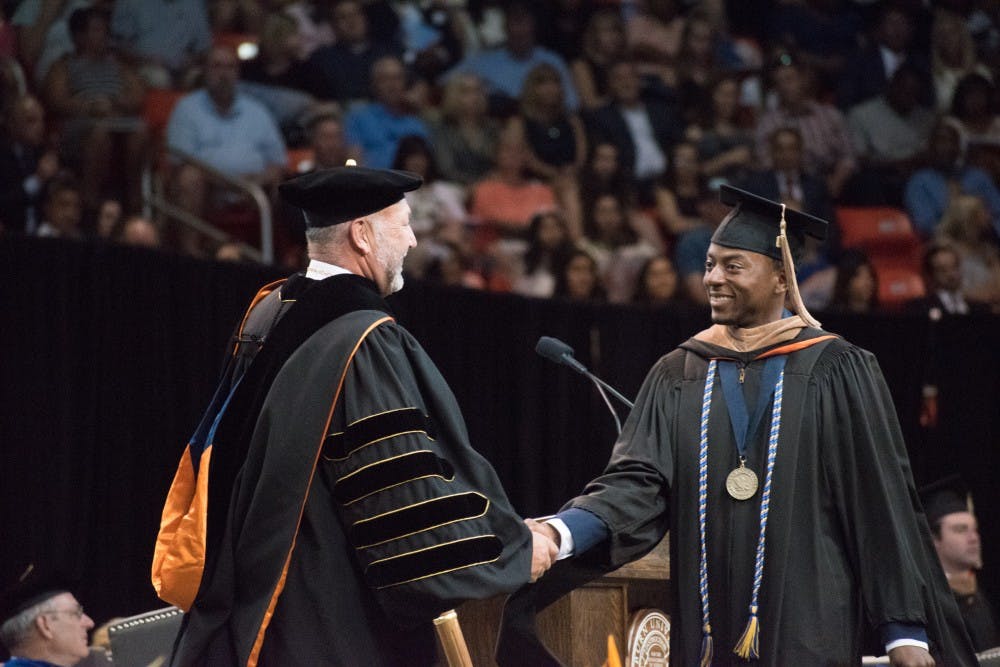 A graduate walks across the stage on Sunday, May 6, 2018, in Auburn, Ala.