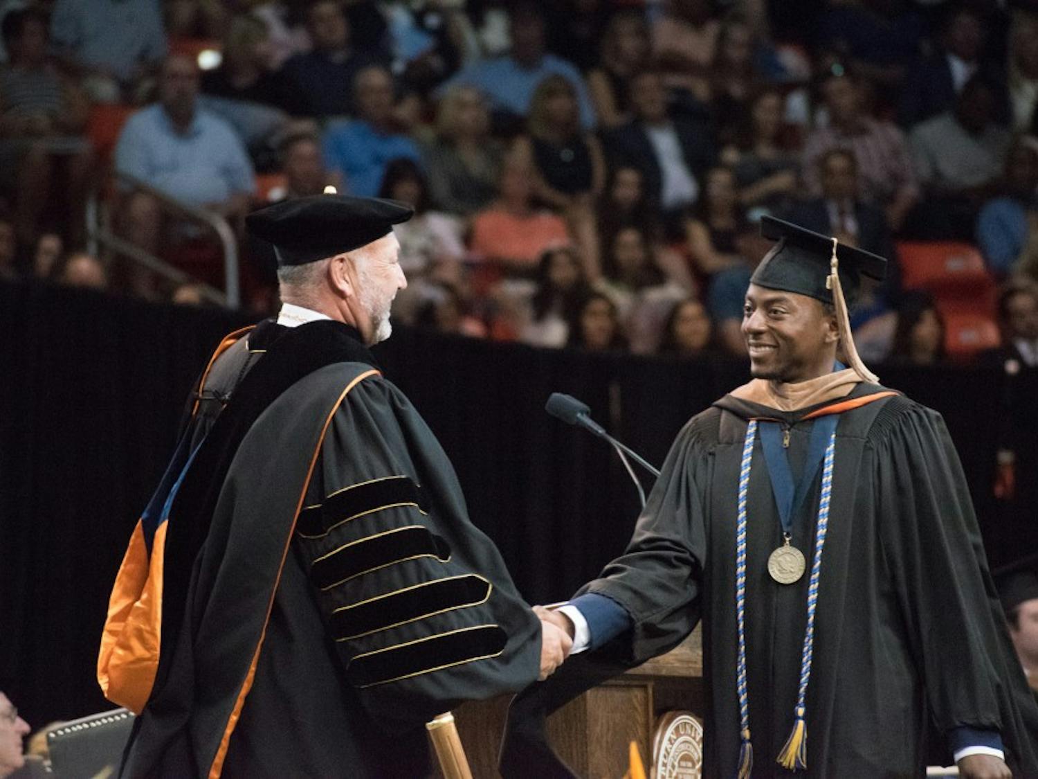 A graduate walks across the stage on Sunday, May 6, 2018, in Auburn, Ala.