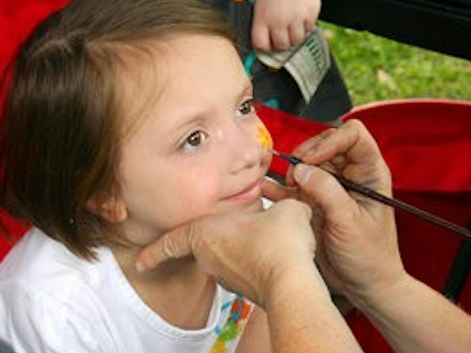 Ansley, 4, from the Opelika area, gets a ladybug painted on her face at the Garden in the Park Festival. (Rebekah Weaver/ASSISTANT PHOTO EDITOR)