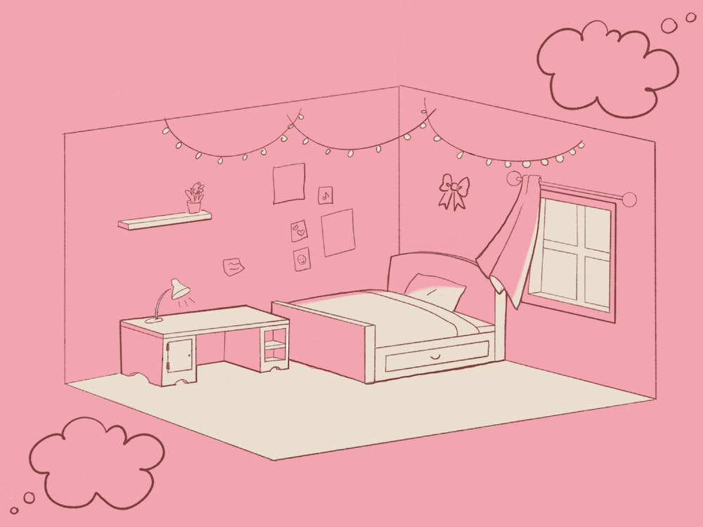 <p>A dorm room features a bed, a desk with a lamp, a window and decorative elements on the walls.</p>