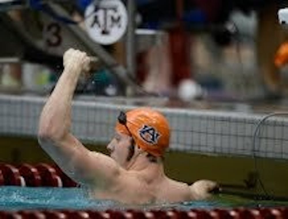 Kyle Owens celebrates after winning the 100-yard back stroke Friday, Feb. 22. (Courtesy of Todd Van Emst)