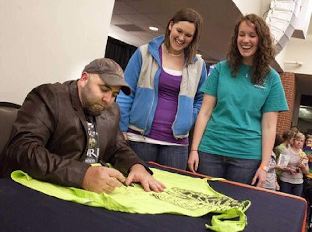 Abbie Gunn, sophomore in pre-med, and Molly Lowery, sophomore in human resource management, meet Duff Goldman after his appearance Tuesday night. (Emily Adams / photo editor)