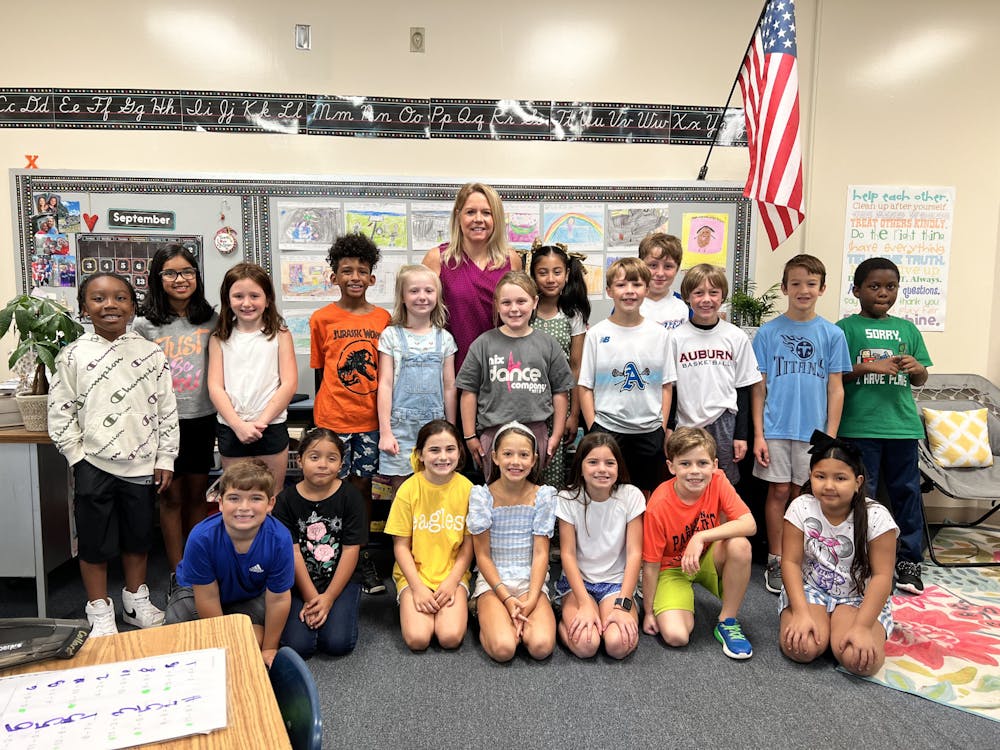 Laura Collard poses with her third-grade class. This is Collard’s 24th year of teaching.