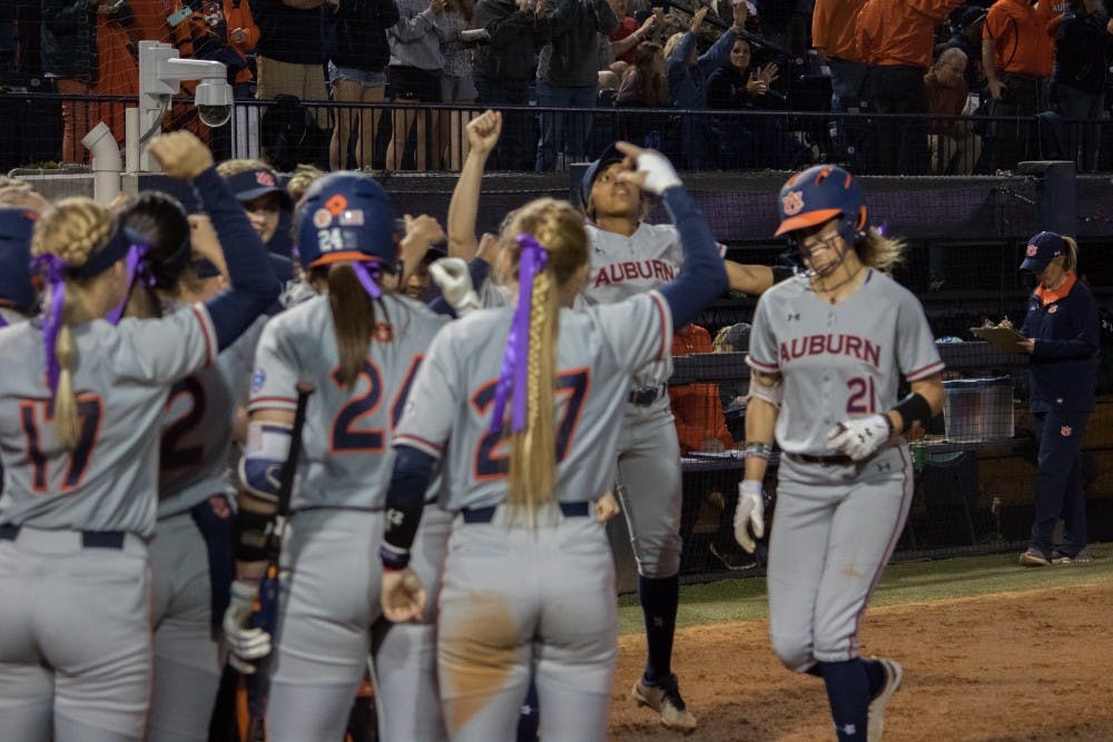 The Auburn Softball team greets Alyssa Rivera (21) at home plate&nbsp;against Arkansas Friday, April 20, 2018, in Auburn, Ala.&nbsp;