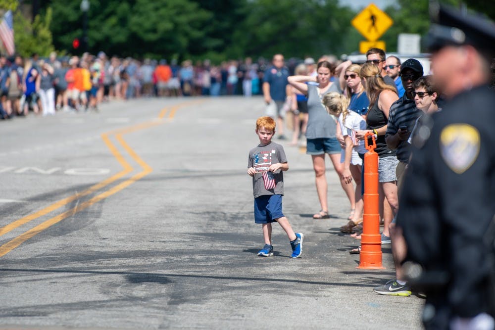 A young boy waits for the Funeral procession of Auburn Police Officer William Buechner on Friday, May 24, 2019, in Auburn, Ala.
