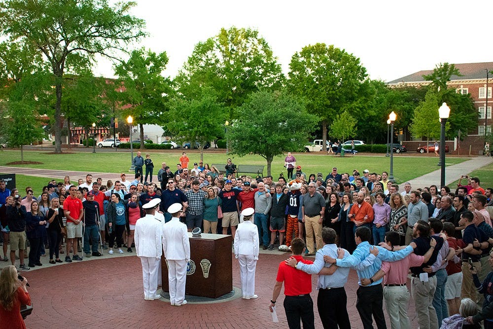 <p>Students, families&nbsp;and Auburn University Navy ROTC&nbsp;members&nbsp;sing the Alma Mater&nbsp;at Ring Night on Thursday, April 19, 2018, in Auburn, Ala.</p>
