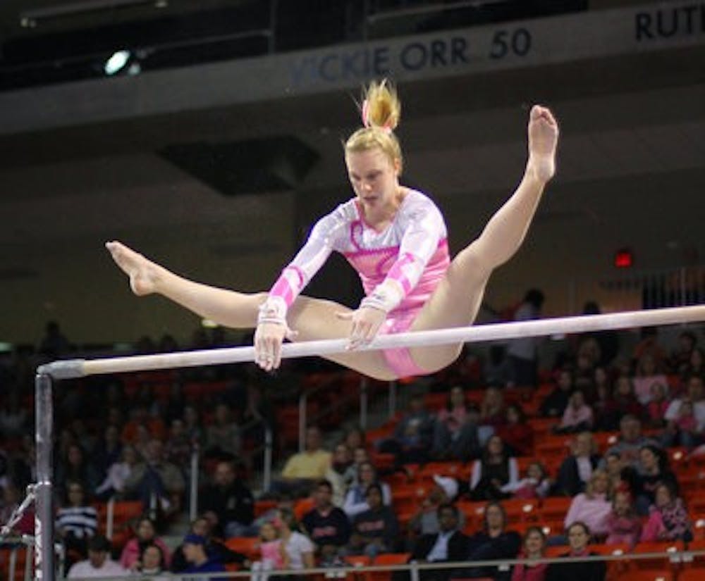 Auburn gymnast Leah Vining catches the bar during her routine. She received a career-high score of 9.825 for the event. Auburn currently has a 1-2 record in SEC meets. (Rebekah Weaver / Assistant Photo Editor)