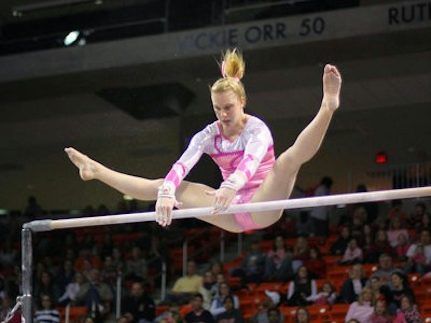 Auburn gymnast Leah Vining catches the bar during her routine. She received a career-high score of 9.825 for the event. Auburn currently has a 1-2 record in SEC meets. (Rebekah Weaver / Assistant Photo Editor)
