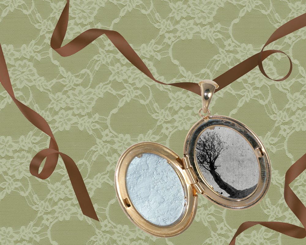 <p>An open locket features a black-and-white image of a tree, set against a lace-covered green background with bronze ribbons.</p>