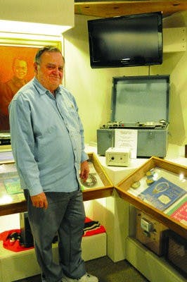 Museum director Glenn Buxton stands with a magnetophone, the World War II equivalent of a tape recorder. There are only two known to exist; one is at the Museum of East Alabama and the other is at the Smithsonian. (Christen Harned / ASSISTANT PHOTO EDITOR)