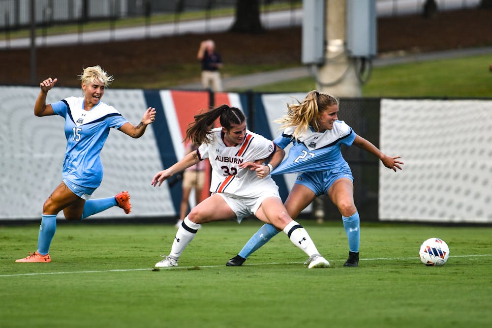 Auburn forward Maddie Simpson (32) fights for the ball during a match between Auburn and Old Dominion at the Auburn Soccer Complex on August 18, 2022.