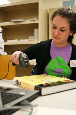Until the new application is released, students must check buyback prices by having their textbooks scanned at the bookstore. (Rebecca Croomes / PHOTO EDITOR)