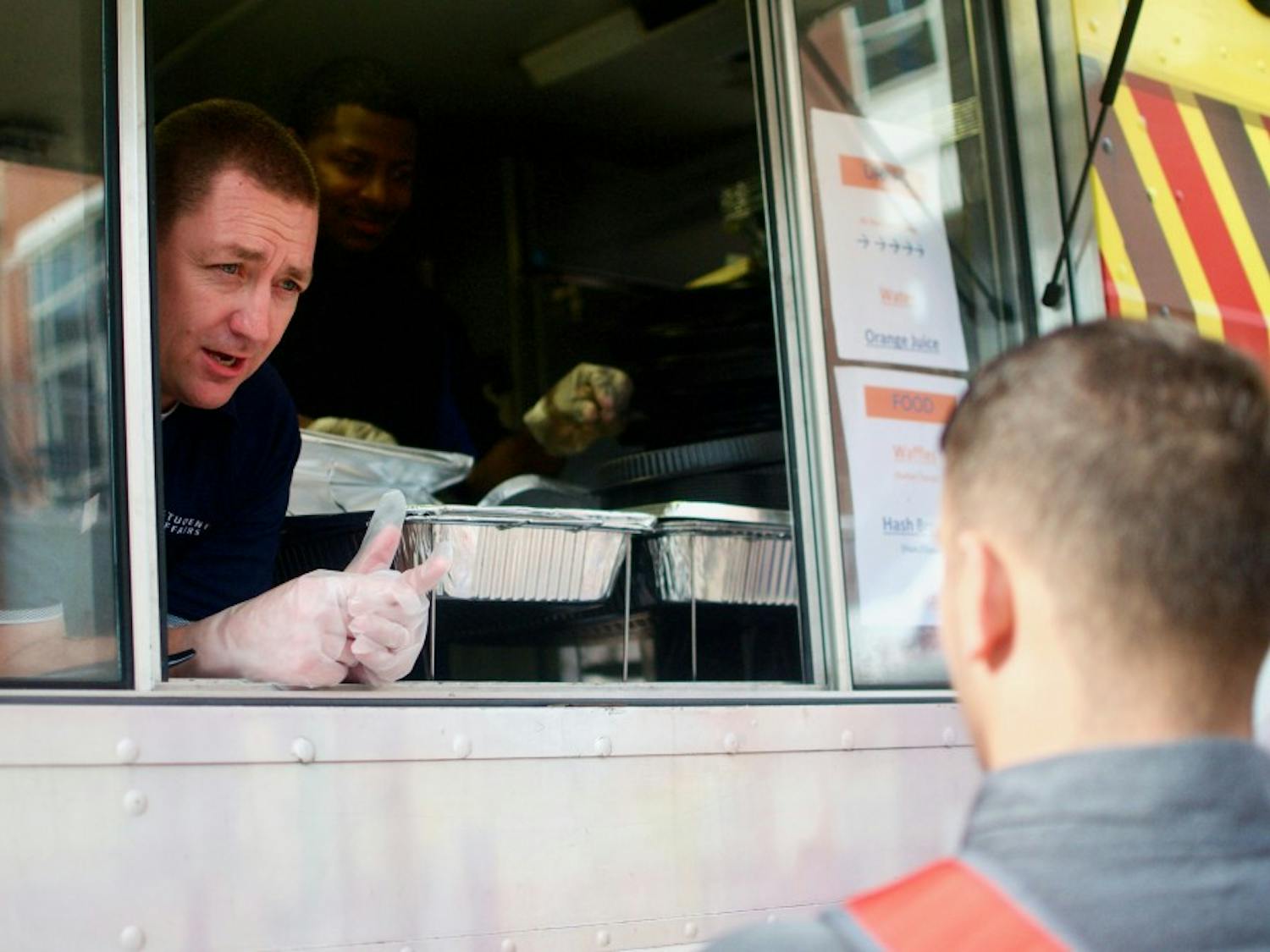 Associate Provost and Senior Vice President for Student Affairs Bobby Woodard serves waffles to students on Wednesday, Aug. 22, 2018 in Auburn, Ala.