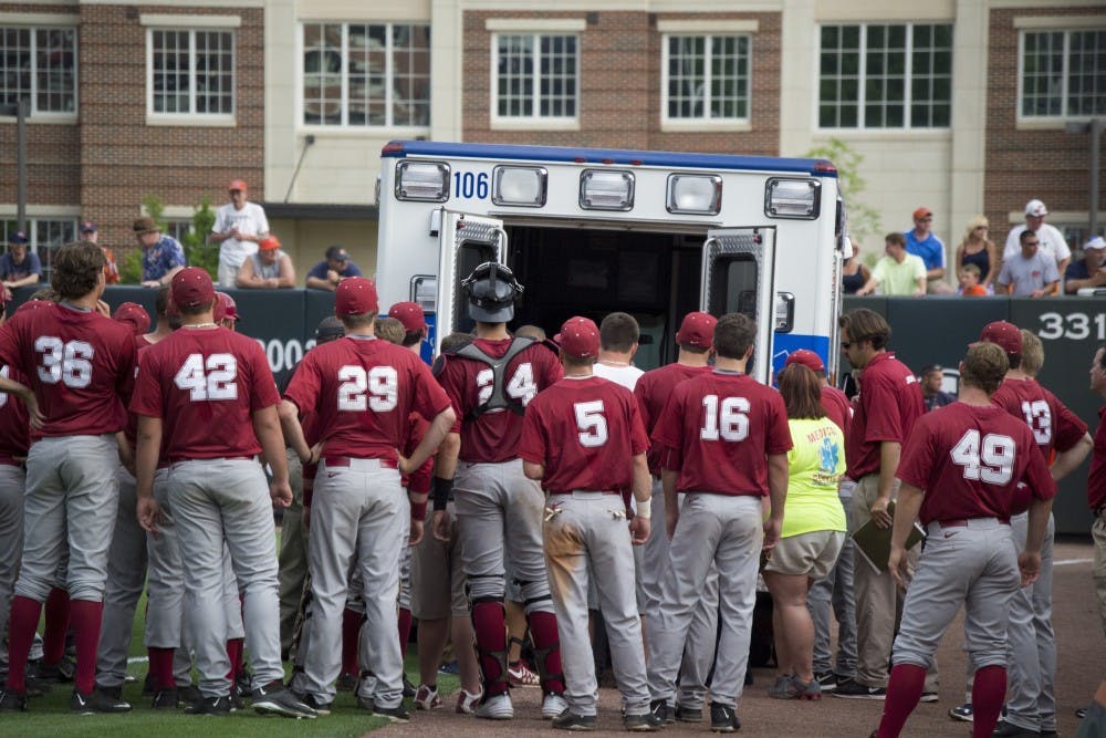 Chance Vincent is carried away in an ambulance after receiving a neck injury. His teammates gather around to see if he is OK. (Jordan Hays | Copy Editor)