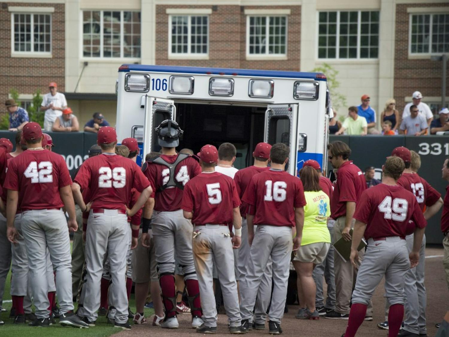 Chance Vincent is carried away in an ambulance after receiving a neck injury. His teammates gather around to see if he is OK. (Jordan Hays | Copy Editor)