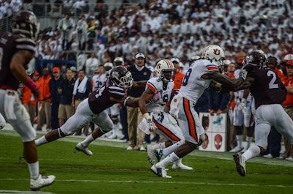 Roc Thomas is defended by Sammie Coates as he runs down the field against MSU.

Raye May / PHOTO EDITOR