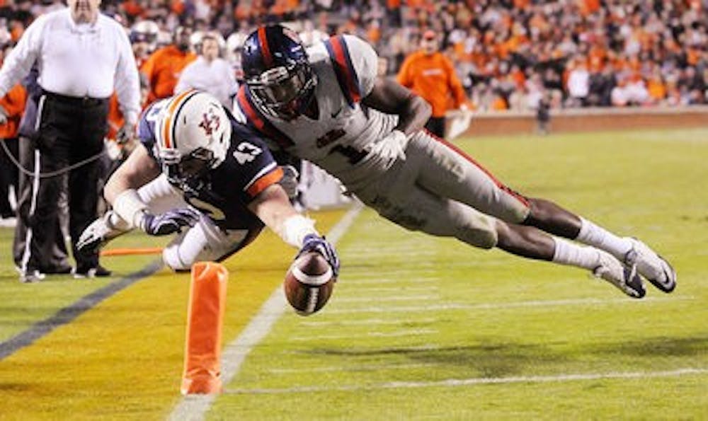Former Auburn tight end Philip Lutzenkirchen dives for the end zone pylon in Auburn's game against Ole Miss in 2011 (Contributed by Auburn Athletics)