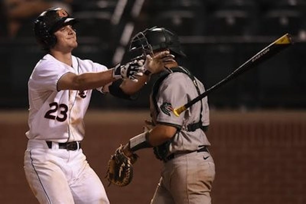 Jordan Ebert (23) tosses his bat in celebration of a walk-off walk. UAB vs Auburn in Auburn, Ala., on Tuesday, May 13, 2014. (Zach Bland / Auburn Athletics)