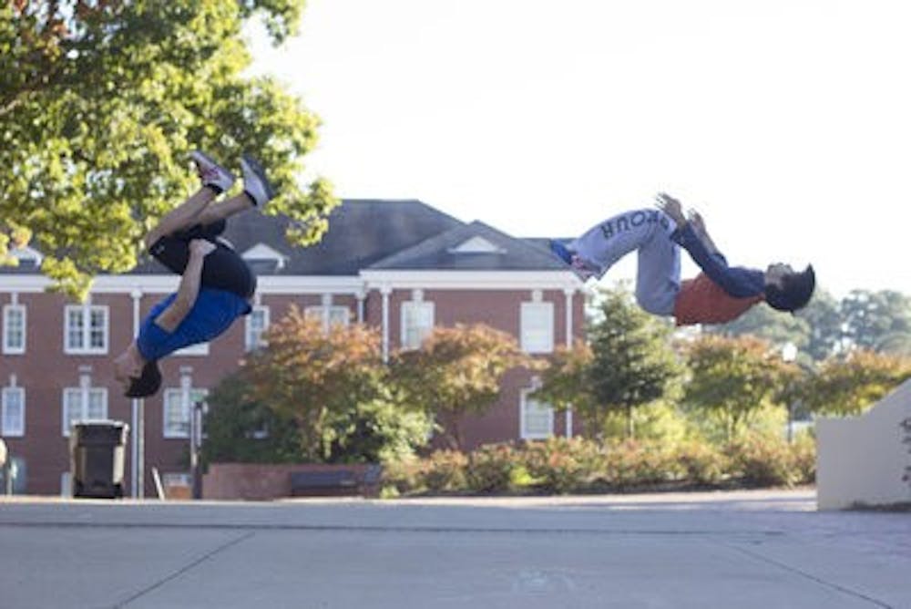 Dylan Westfall and Filipe Magalhaes backflip at the same time on the Haley concourse.