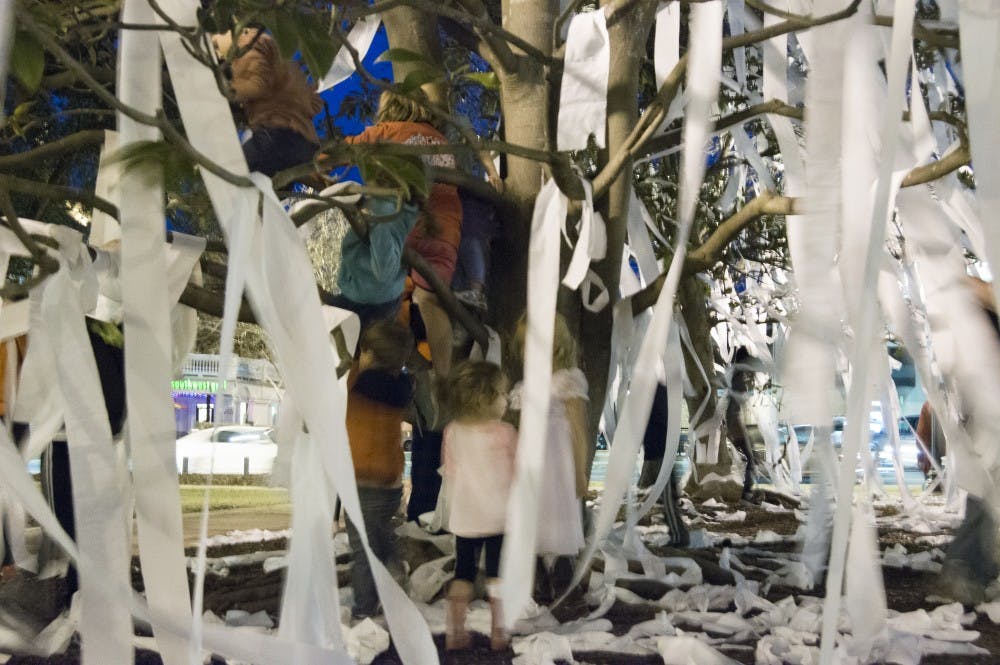 Children play in the trees at Toomer's Corner after Auburn's victory over Kentucky at the Auburn Arena on Saturday, Jan. 16, in Auburn, Ala. Auburn won 75-70