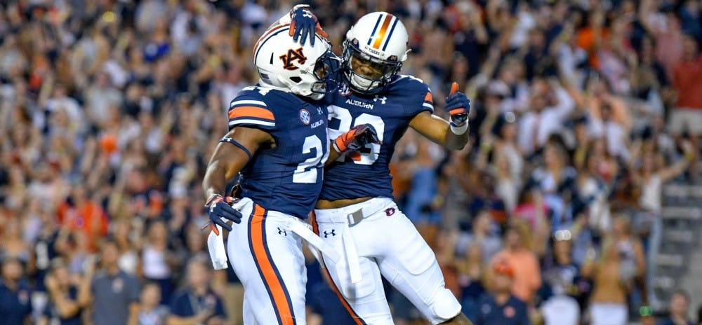 <p>Daniel Thomas (24) and Ryan Davis (23) celebrate after a touchdown during &nbsp;Auburn Football vs. Arkansas on Saturday, Sept. 22, 2018 in Auburn, Ala.</p>