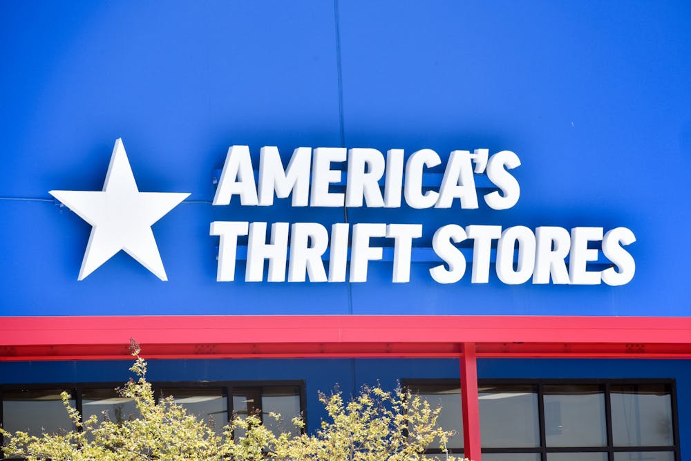 <p>The front-door sign of America's Thrift Store in Opelika, Alabama, on April 4, 2022.</p>