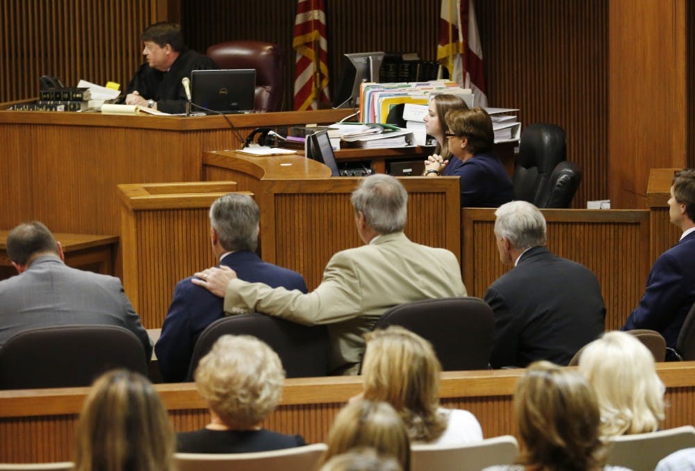 Mike Hubbard sits in the middle while attorney David McKnight has his arm around his shoulder after the Alabama Speaker Mike Hubbard Trial on Friday, June 10, 2016  in Opelika, Ala.Todd J. Van Emst/Opelika-Auburn News/Pool