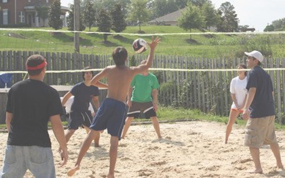 Members of the Delta Chi Fraternity and their friends take part in a friendly Saturday afternoon game of beach volleyball at their fraternity house on Lem Morrison.      Ashley Draa/Photo Editor